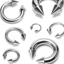 Stainless steel piercing of silver colour - horseshoe finished with pikes