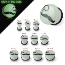 White ear plug glowing in dark, black mustache and monocle
