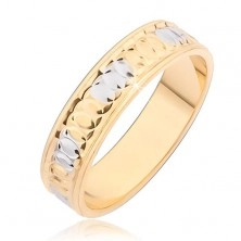 Gold band ring with circular notches and silver spots