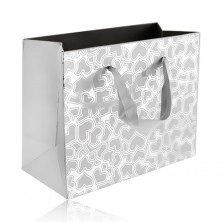 Gift bag of silver colour, matt hearts on shiny background