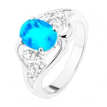 Ring in silver colour, big blue oval zircon, asymmetric lines