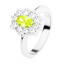 Ring in silver colour, yellow-green oval zircon lined with round clear zircons