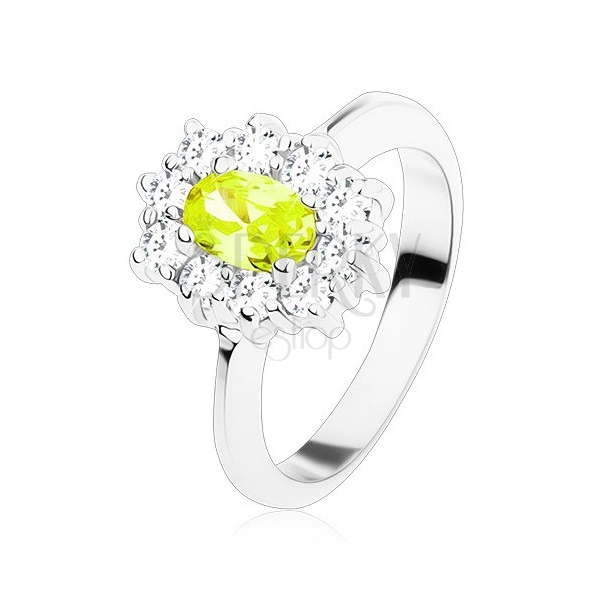 Ring in silver colour, yellow-green oval zircon lined with round clear zircons