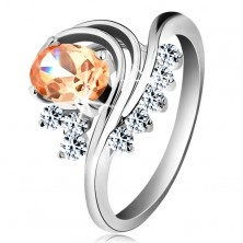 Ring in silver colour, bent lines, coloured oval zircon and clear zircons