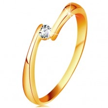 Ring made of yellow 14K gold - clear diamond between the narrowed ends of shoulders