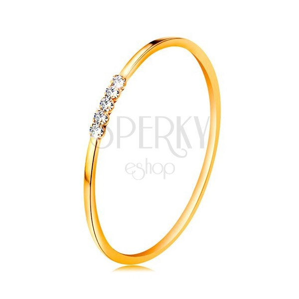Ring made of yellow 14K gold - line of clear zircons, thin shiny shoulders