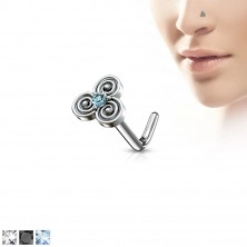 Curved steel nose piercing with a celtic motif, zircon in the middle