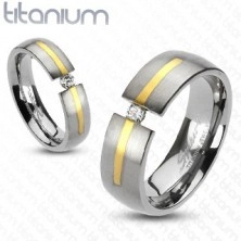 Titanium ring in silver color with golden stripe and zircon