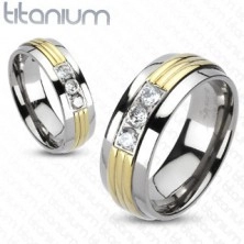 Titanium ring - central part in gold colour, three clear zircons